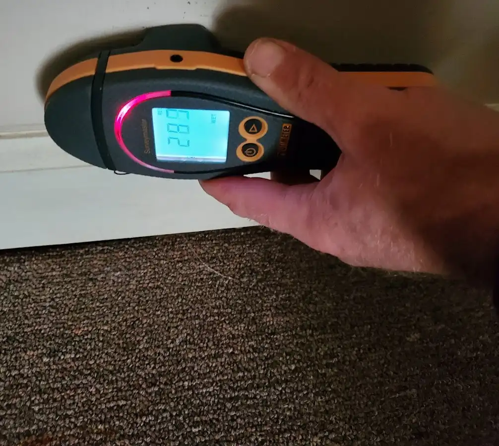 Moisture detection at baseboard during Storm Damage Restoration in Shelby